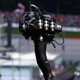 A different, clearly identified jetpacker, no less villainous than his LA counterpart, zooms around an F1 racetrack.